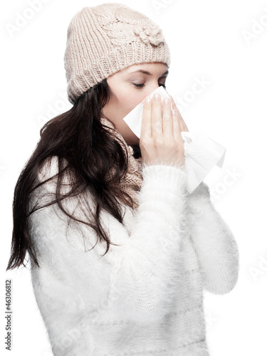 Photo: Young Lady in Winter clothes blows her nose Young Lady in Winter clothes blows her nose