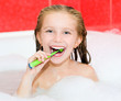 girl brushing teeth in bath