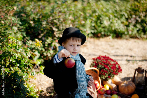 Photo: boy in a black coat and hat at the picnic boy in a black coat and hat at the picnic