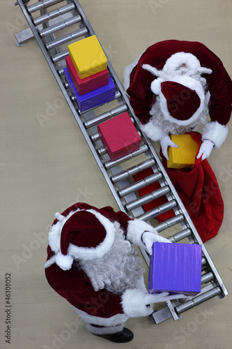 Photo: santa clauses preparing gifts in factory santa clauses preparing gifts in factory