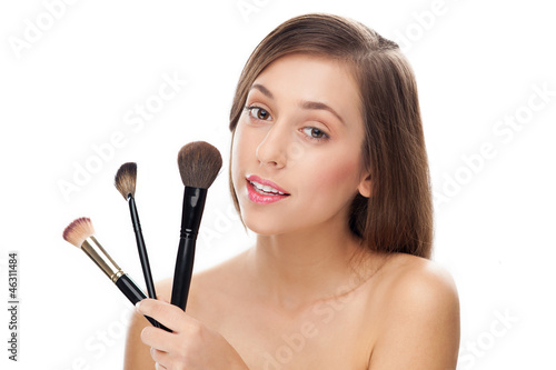 Photo: Woman holding make-up brushes Woman holding make-up brushes