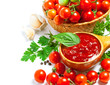 Red tomato sauce in a spoon and ingredients, isolated in white