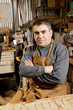 Photo: Artisan at workbench arms folded Artisan at workbench arms folded
