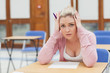 Foto: Woman looking worried over exam paper Woman looking worried over exam paper