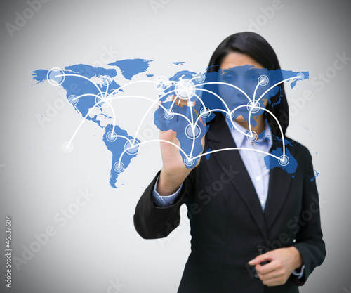 Photo: Businesswoman pressing world map hologram Businesswoman pressing world map hologram