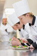 Chef's applying finishing touches to salads