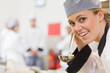Smiling chef about to taste soup