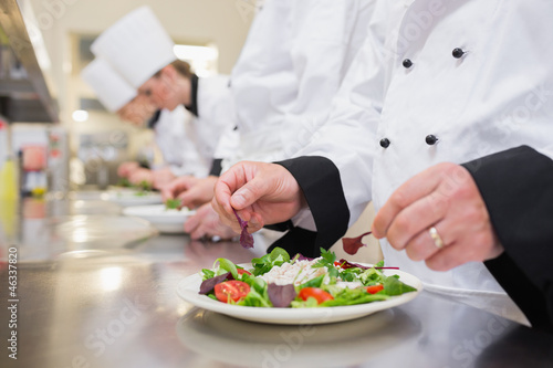 Photo: Chef garnishing salads Chef garnishing salads