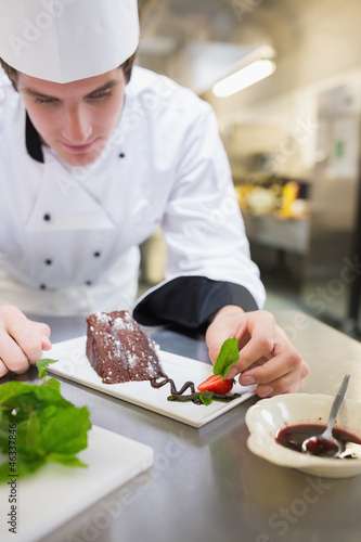 Photo: Chef putting mint on the desert plate Chef putting mint on the desert plate