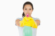 Woman pointing a spray bottle at the camera