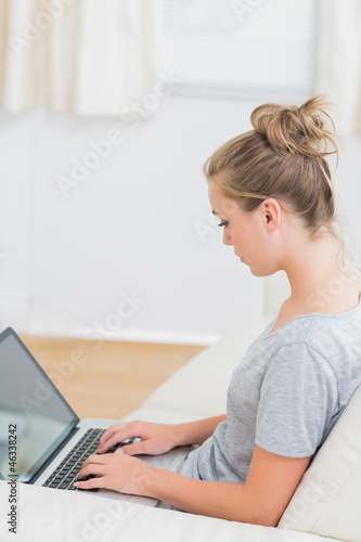 Photo: Blonde typing on the notebook Blonde typing on the notebook