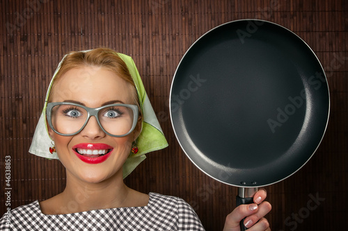 Photo: Close-up funny woman cook with pan - vintage concept Close-up funny woman cook with pan - vintage concept
