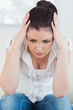 Unnerved woman holding hands at her head