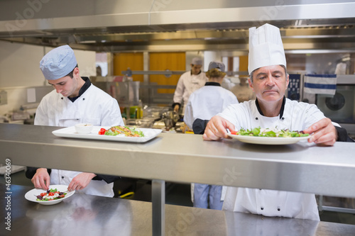 Photo: Head chef inspecting salad before service Head chef inspecting salad before service
