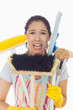 Distressed woman holding cleaning tools