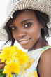 Photo: Woman wearing hat and holding flowers Woman wearing hat and holding flowers