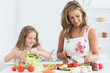 Mother and daughter preparing vegetables