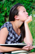 Young Asian student girl with books outdoor