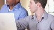 Vidéo : Architect and small business owner discussing blueprint and using laptop inside building under construction Architect and small business owner discussing blueprint and using laptop inside building under construction