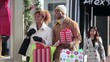 Couple in warm clothing Christmas window shopping on urban street