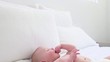 Caucasian baby laying on bed and squirming