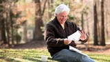 Video: Smiling senior Caucasian man receiving good news in mail and showing paper to camera Smiling senior Caucasian man receiving good news in mail and showing paper to camera