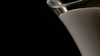 Milk pours from pitcher (slow motion)