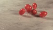Cherry tomatoes falling onto marble surface (slow motion)