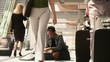 Business traveler searching through clothes on airport floor