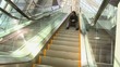 Caucasian businessman sitting on ascending escalator
