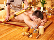 Woman getting bamboo massage.