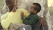 African American father siting with son in his lap