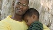 African American father comforting son