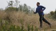 Mixed race man jogging in remote area listening to music