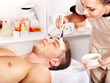 Clay facial mask in beauty spa.