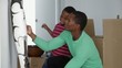 African American father with son and african sculpture