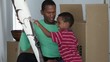African American father with son and african sculpture