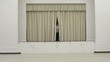 Hispanic man steps out from behind curtains on a stage, checks watch and clipboard