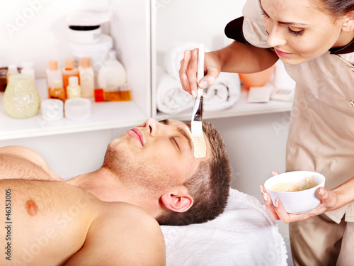 Photo: Clay facial mask in beauty spa. Clay facial mask in beauty spa.