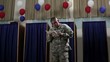 Hispanic soldier in front of voting booths