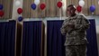 Hispanic soldier walking out from voting booth