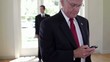 Businessman text messaging on cell phone