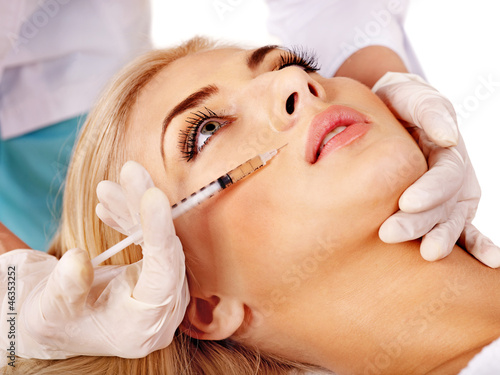 Photo: Doctor woman giving botox injections. Doctor woman giving botox injections.