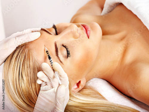 Photo: Woman giving botox injections. Woman giving botox injections.