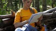 Hispanic woman taking a break from a hike to draw