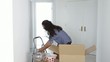 Latin woman unpacking dishes