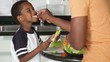 African American father with son preparing salad