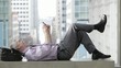 Video: Caucasian businessman laughing while laying on a bench text messaging on cell phone Caucasian businessman laughing while laying on a bench text messaging on cell phone