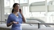 Black businesswoman answers cell phone and laughs