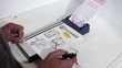 Hispanic man starting to fill out ballot in voting booth